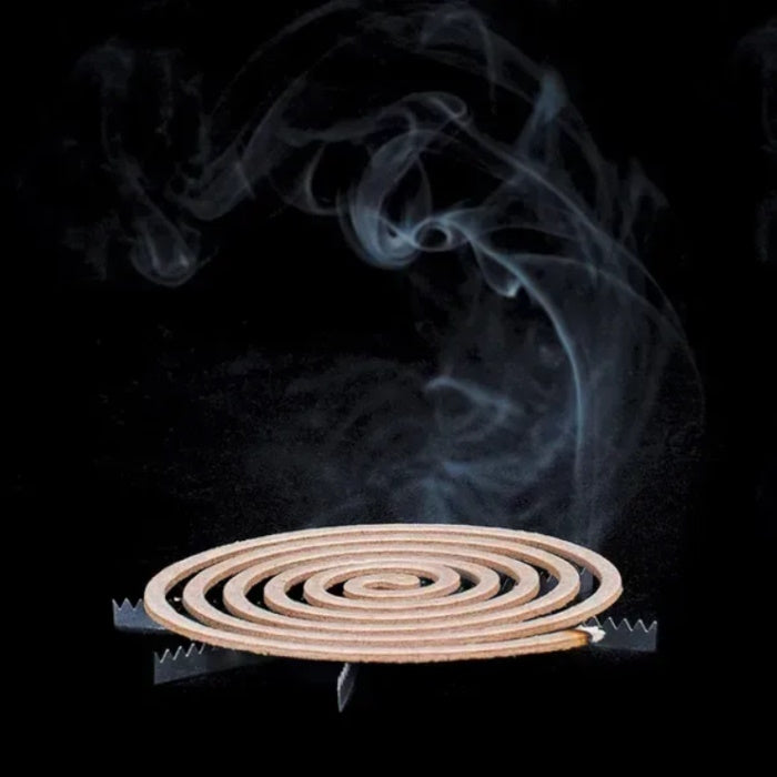 Load image into Gallery viewer, A spiral-shaped insect repellent coil smoldering on a metal stand with smoke