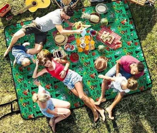 Load image into Gallery viewer, Family enjoying a picnic on a colorful mat outdoors
