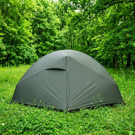 Green Cresta 2 Alu tent pitched on grass in a lush forest lifestyle setting