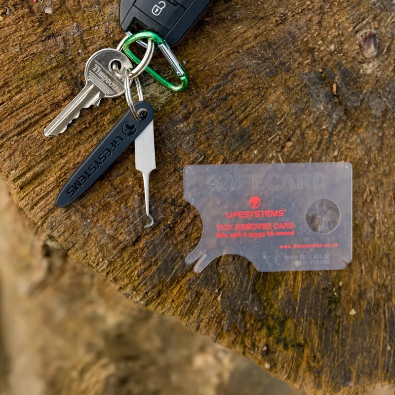 Load image into Gallery viewer, Lifesystems Tick Remover Card and keychain tool on a rustic wooden background
