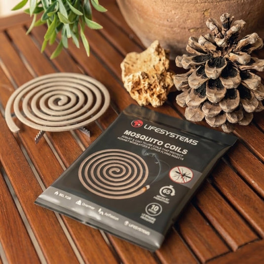 Lifesystems mosquito repellent coils and retail pack on a wooden garden table