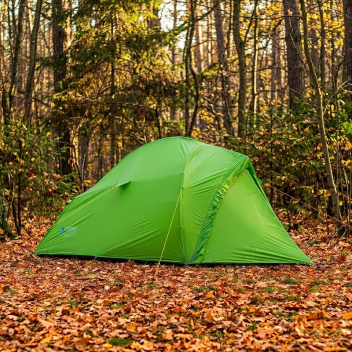 Load image into Gallery viewer, Bright green Ligera 2 backpacking tent pitched on autumn leaves in a sunny woods
