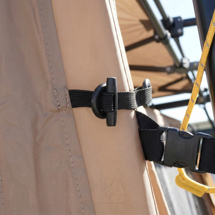 Load image into Gallery viewer, Close-up of toggle fasteners and buckle securing the side panel to the shelter
