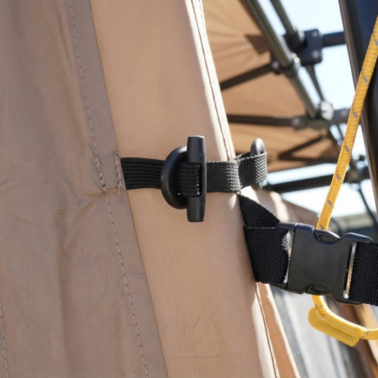 Close-up of toggle fasteners and buckle securing the side panel to the shelter