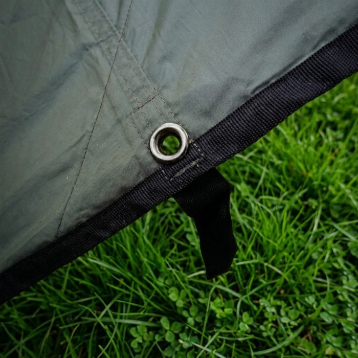 Load image into Gallery viewer, Detail of reinforced tarp stitching, webbing, and a pressed metal grommet.
