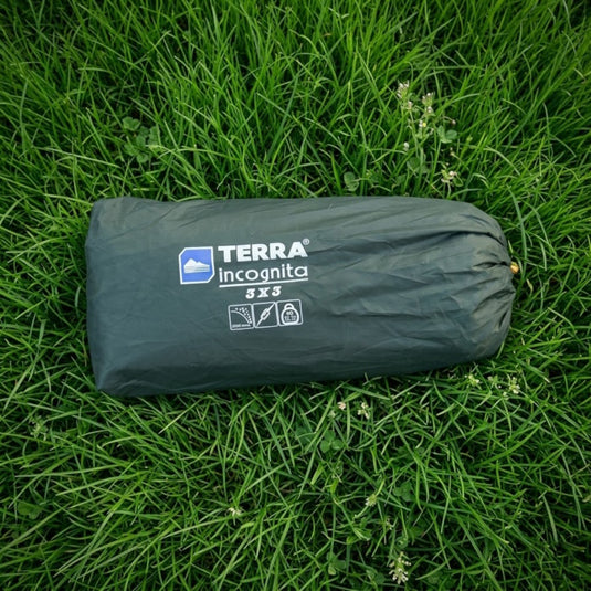 Compact 3x3m camping tarp in a storage bag, ideal for low-volume packing