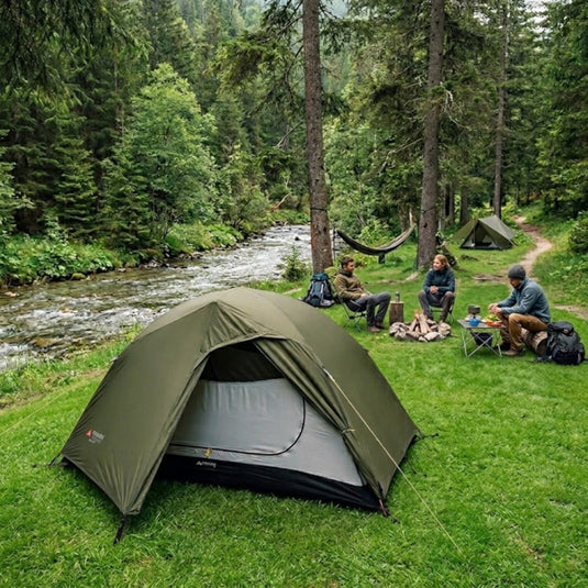 SkyLine 2 green 2-person tent pitched in a grassy field with mountain view